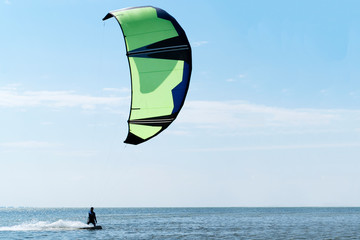 Kite-surfing against a beautiful sky. Holidays on nature.