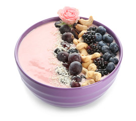 Bowl with pink yogurt, nuts and fresh fruits on white background
