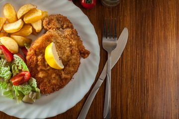Breaded viennese schnitzel with baked potatoes