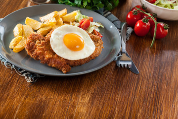 Breaded viennese schnitzel with fried agg