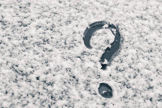 Finger-drawn Question Mark on a snow-covered glass surface