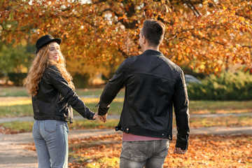 Loving young couple on romantic date in autumn park