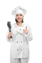 Young female chef on white background