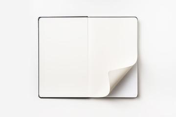 Top view of black notebook with curl rolled page
