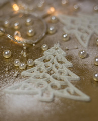 Background for winter celebrations with Christmas tree ornaments, pearls and snow.