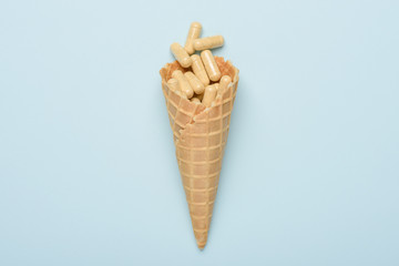 Pills in ice cream waffer cone medicine concept