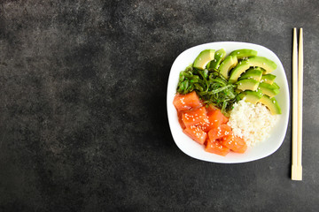 Hawaiian dish poke bowl on black background. 