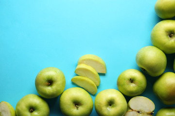 Ripe tasty apples on color background, top view