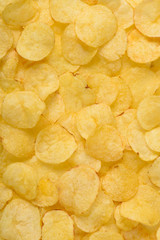 Crispy potato chips texture background top view closeup