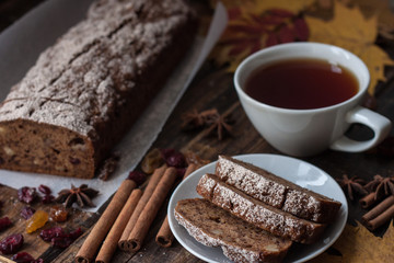 Homemade banana bread with anis star and cinnamon on a dark wooden background