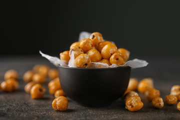 Bowl with roasted chickpeas on grey table