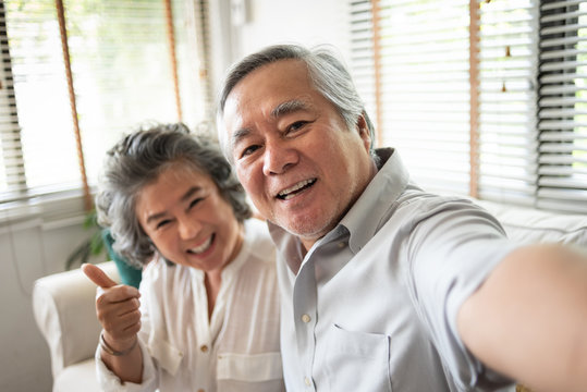 Senior Couple taking selfie photos with smartphone.