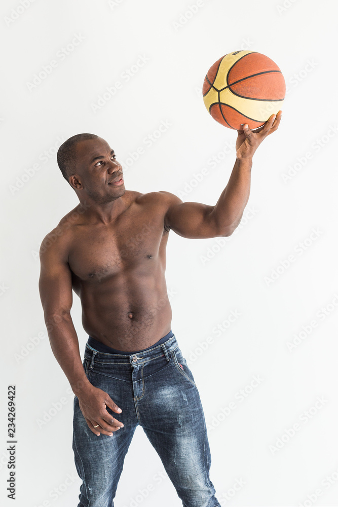 Poster muscular afro american athlete with basketball ball on white background