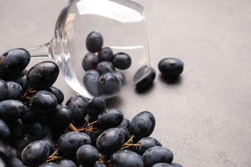 Empty wineglass and grapes on table, closeup