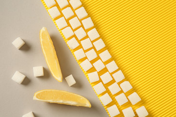 Pieces of lemon with sugar on color background