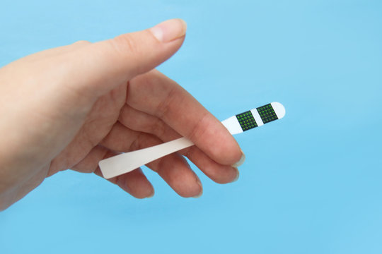 individual color dot oral thermometer in woman hand