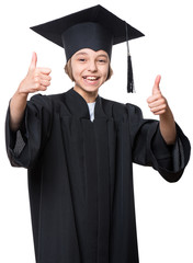 Graduate little happy girl student in black graduation gown with hat making thumbs up gesture - isolated on white background. Child back to school and educational concept.