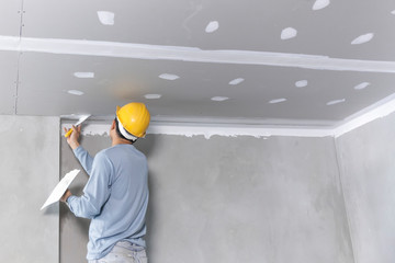 Craftsman working with plaster gypsum ceiling for interior build gypsum board ceiling