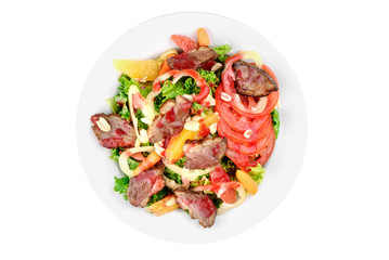 Salad with meat, pear, tomato, on a white plate isolated on white background isolated on white background. top view. flat lay