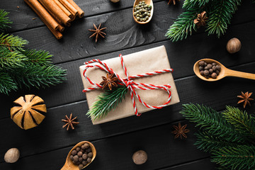 Vintage gift box with christmas decoration on dark wooden background.