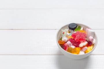 Colorful candies on wooden background