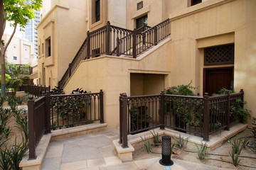 Fototapeta na wymiar Street in old town. Arabic style townhouses in Dubai. Cozy expensive luxury neghborhood.
