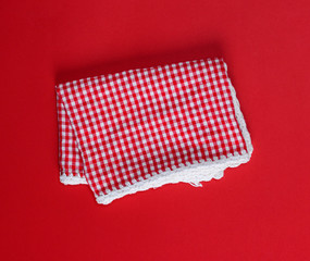 folded red cotton kitchen towel in the box on a red background