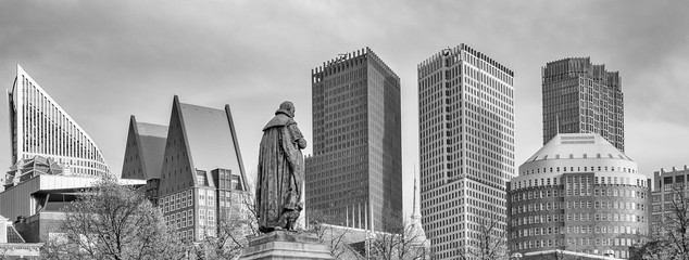 Panorama photo of the statue of William vam Orange on het Plein in the Hague with the sky-line in the background in black and white