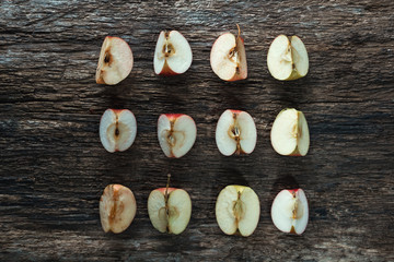 Slices of fresh juicy red apples/ Slices of fresh juicy red apples on old wooden tabletop