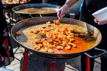 Pan with roasted prawns for sale outdoors