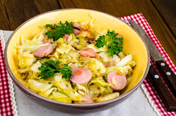Stewed cabbage with slices of sausages