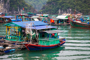 Fototapeta na wymiar Floating fishing village and fishing boats in Cat Ba Island, Vietnam, Southeast Asia. UNESCO World Heritage Site.