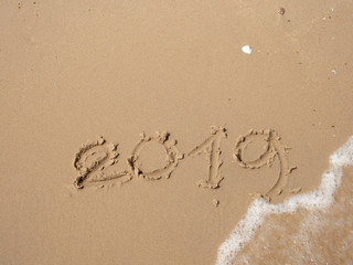 Fototapeta premium Sand written numbers on beach