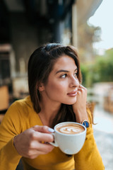 Beautiful girl drinking cup of coffee.