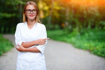 pay attention. a young girl who is a doctor stands outside, show