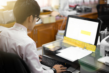 Man is sitting and working, Computer screen in office.