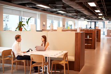 Young Businessman Having Informal Interview In Cafeteria Area At Graduate Recruitment Assessment Day
