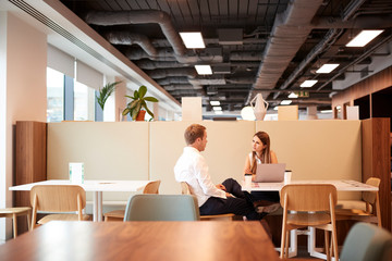 Young Businessman Having Informal Interview In Cafeteria Area At Graduate Recruitment Assessment Day