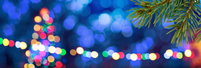 Blue unfocused background with colored christmas tree