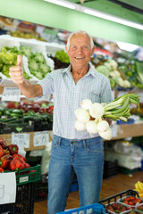 Delighted senior man shopping in greengrocery