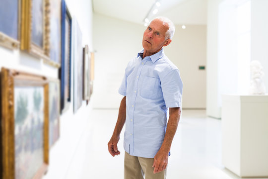Man observing painting gallery