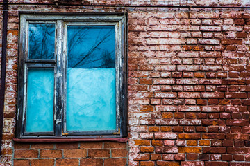old wooden window in an old brick wall