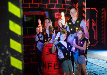 Fototapeta na wymiar Family posing with laser pistols