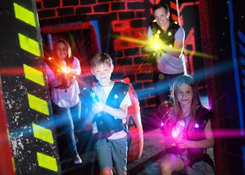 Brother and sister playing laser tag in beams
