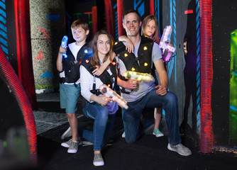 Obraz na płótnie Canvas Kids and parents with laser guns