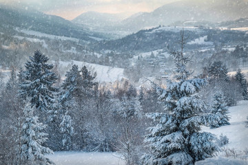 Nice mountains view in snowy sunny day under blue sky with sun