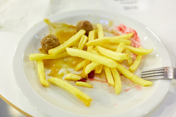 the remains of food on a plate in a fast food restaurant