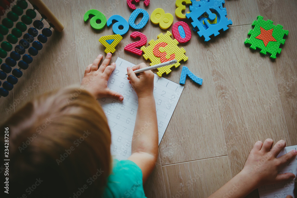 Wall mural little boy and girl learn to write and calculate numbers
