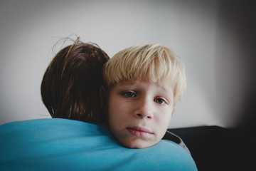 Father comforting sad stressed child, parenting, sorrow