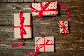 gifts on a wooden background with a red ribbon